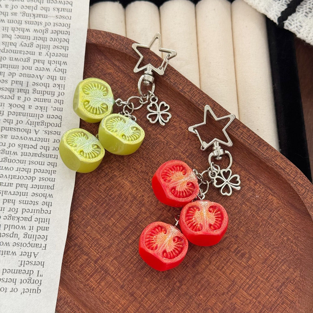 Realistic miniature tomato keychain featuring detailed red fruit & green stem. Perfect bag charm accessory.