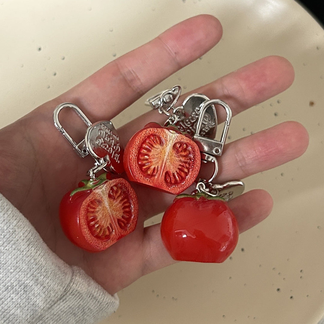 Vibrant red tomato keychain charm. Adds a fun, unique accessory to keys, bags, or purses. A novelty gift.
