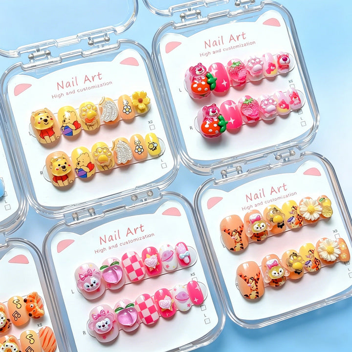 Hand model wearing colorful cartoon press-on nails, perfect for quick & decorative nail art.