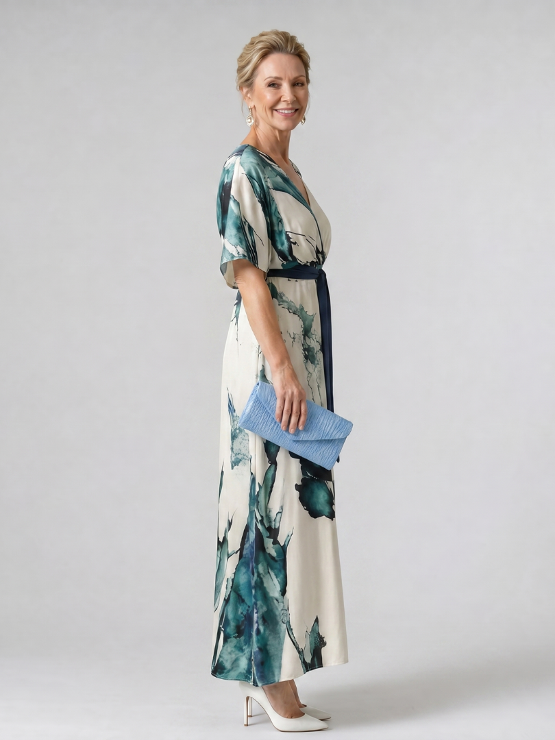 Elegant women's abstract print maxi dress featuring flutter sleeves and tie waist, perfect for summer events or evening wear.