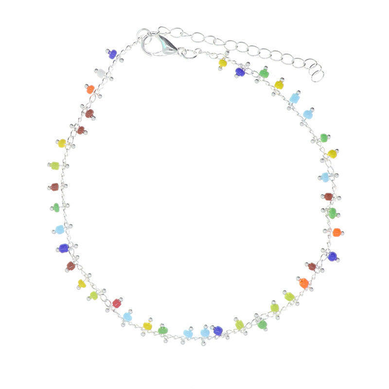 Close-up of a women's vibrant beaded tassel anklet, showcasing its colorful beads, intricate design, and boho charm.