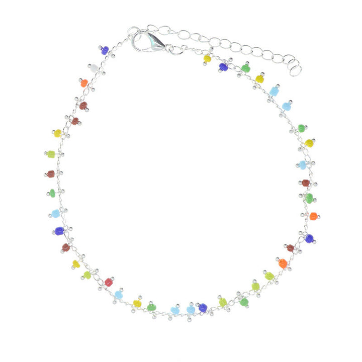 Close-up of a women's vibrant beaded tassel anklet, showcasing its colorful beads, intricate design, and boho charm.