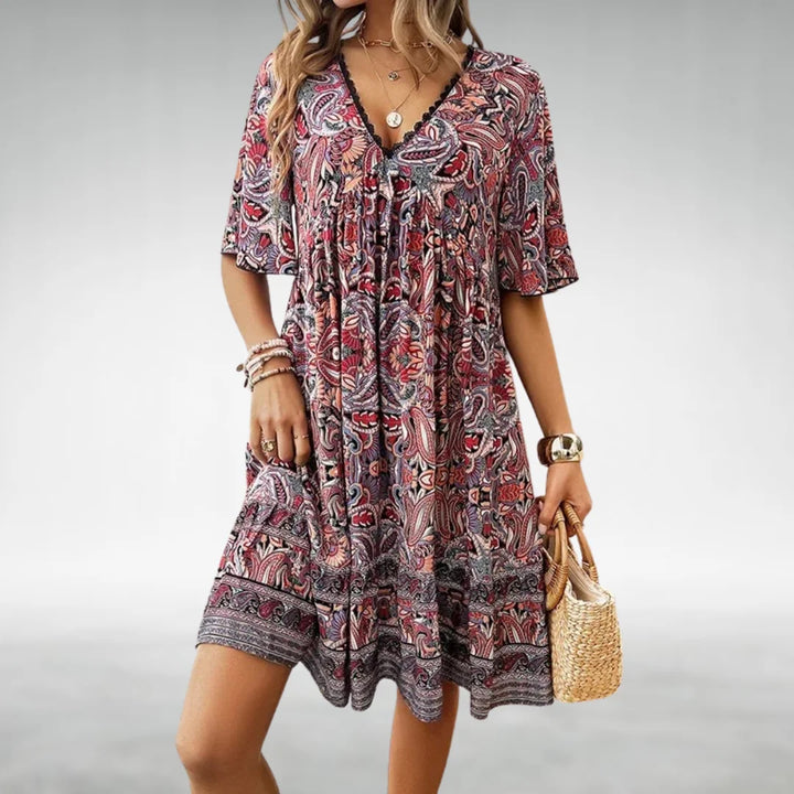Stylish women's printed mini dress with a flattering V-neck and graceful flutter sleeves, great for casual summer outings.