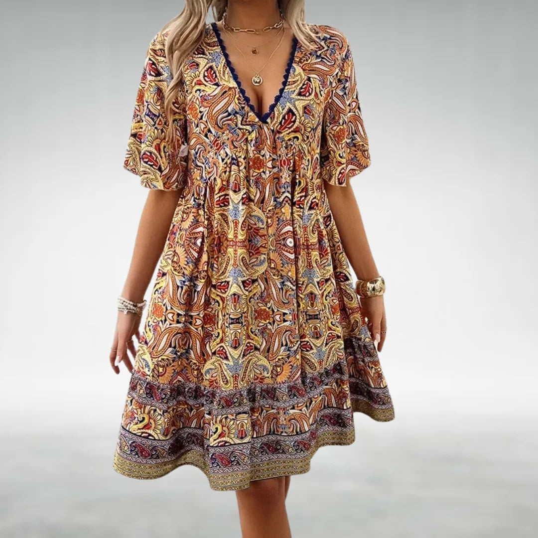 Boho women's mini dress with a unique print, V-neckline, and flutter sleeves, offering a vibrant and chic summer look.
