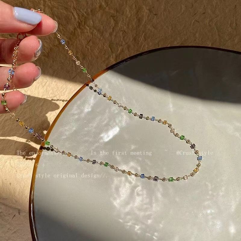 Beaded charm bracelet for women, showcasing a spectrum of bright colors and delicate charms. Stylish jewelry.