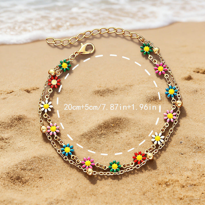 Close-up of a women's adjustable colorful floral & daisy charm anklet, vibrant and playful.