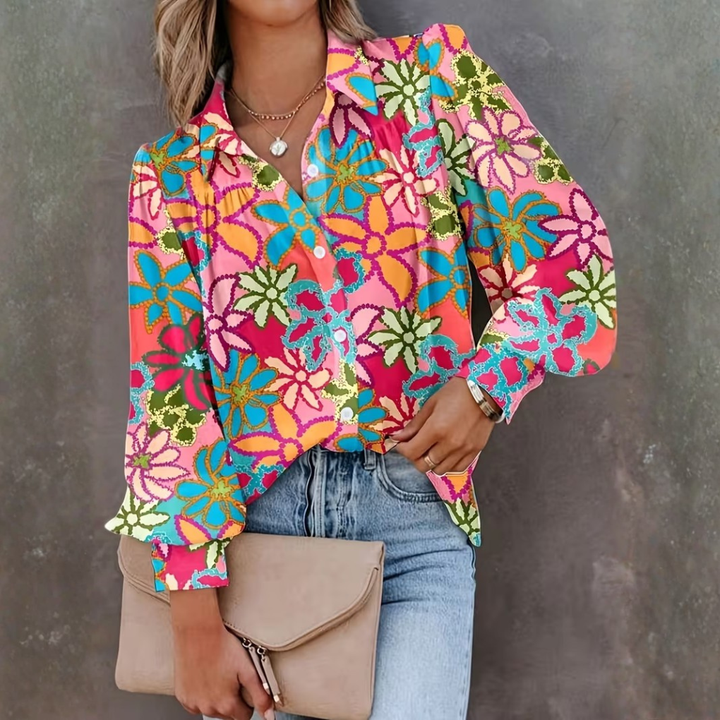 Vibrant women's floral print long-sleeve button-front shirt with lapel collar. Stylish casual top for spring fashion.
