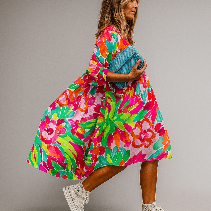 Vibrant women's oversized floral print midi dress with puff sleeves. A-line style, perfect for spring/summer fashion.