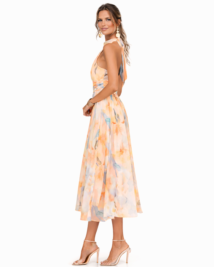 Flowing women's midi dress featuring artistic watercolor print & flattering halter neck, great for events.