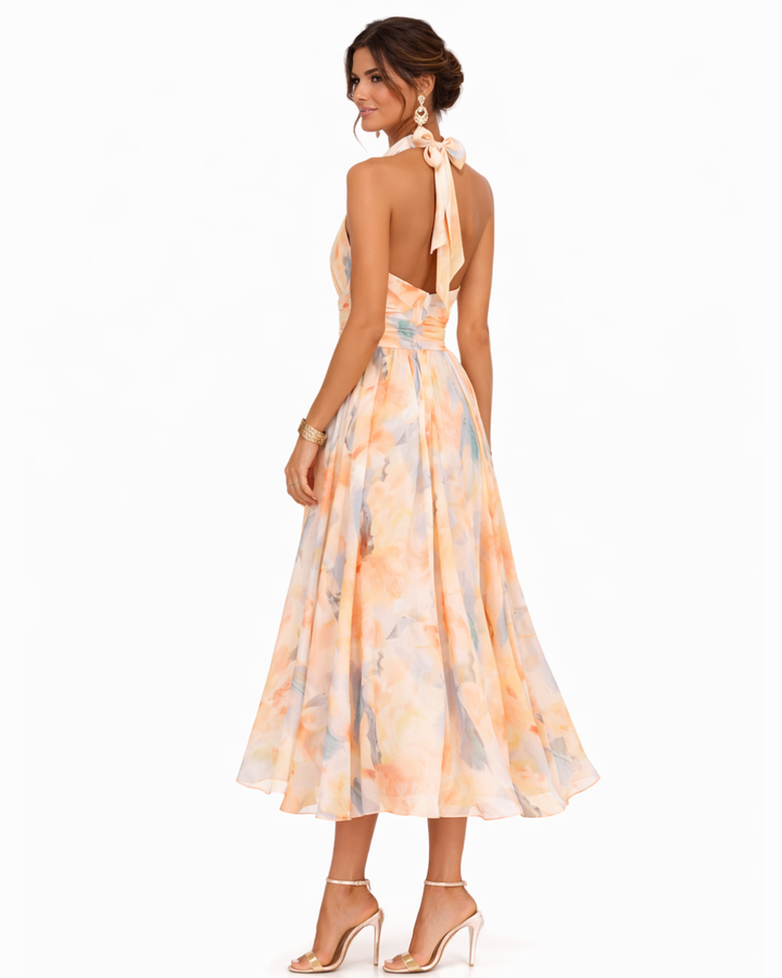 Artistic women's watercolor print halter neck midi dress, vibrant and chic for any special summer event.