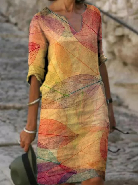 Vibrant yellow women's v-neck midi dress with a colorful print, perfect for comfortable summer casual style.