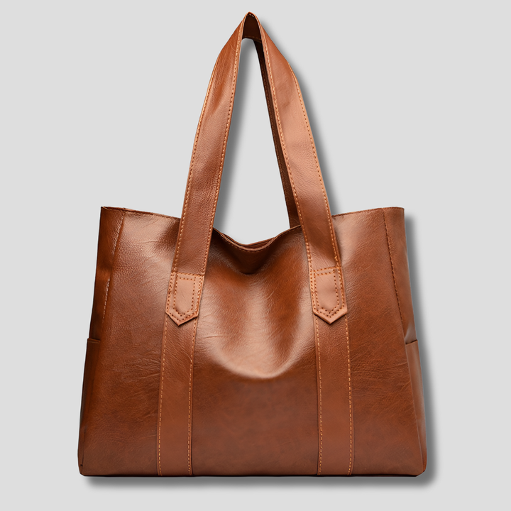 Vintage brown leather women's shoulder bag with front flap. Versatile everyday handbag, crossbody, or tote style.