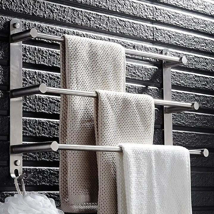 Durable stainless steel wall-mounted towel rack with hooks, offering practical bathroom organization & storage.