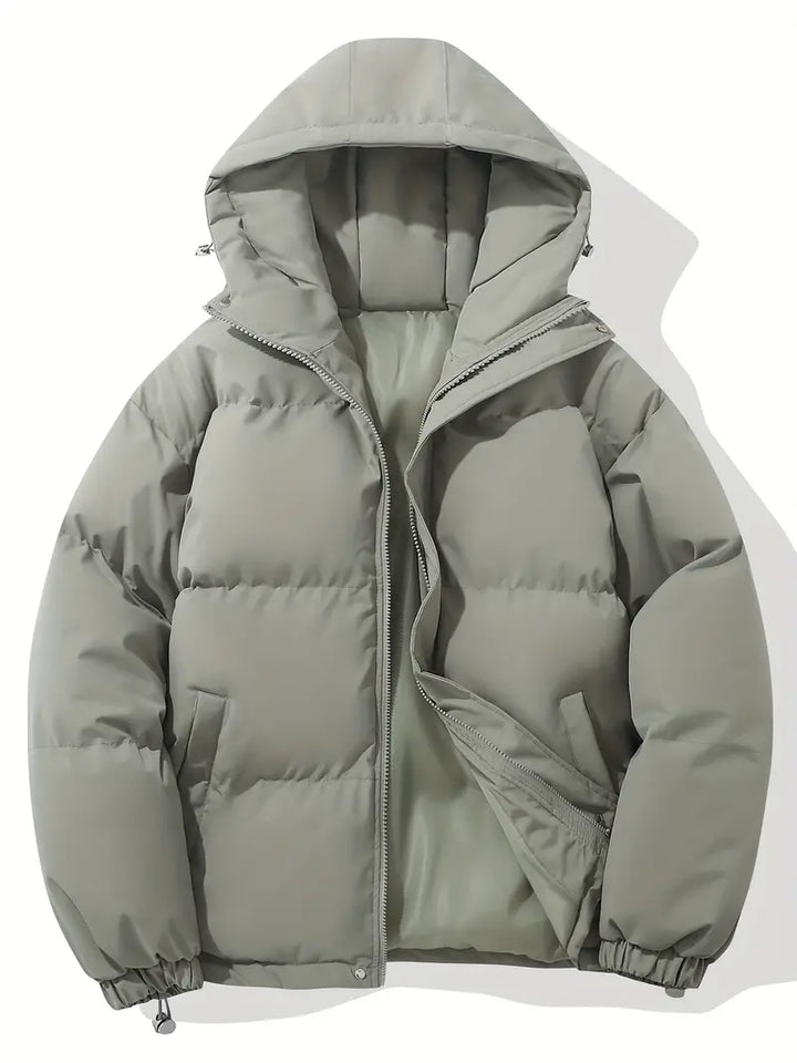 Durable women's quilted puffer jacket, featuring a protective hood. Excellent warm outerwear for cold conditions.