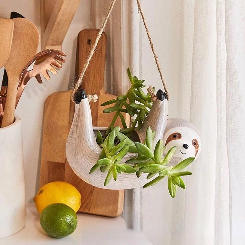 Whimsical ceramic sloth hanging planter, perfect for indoor plants, succulents & charming home decor.