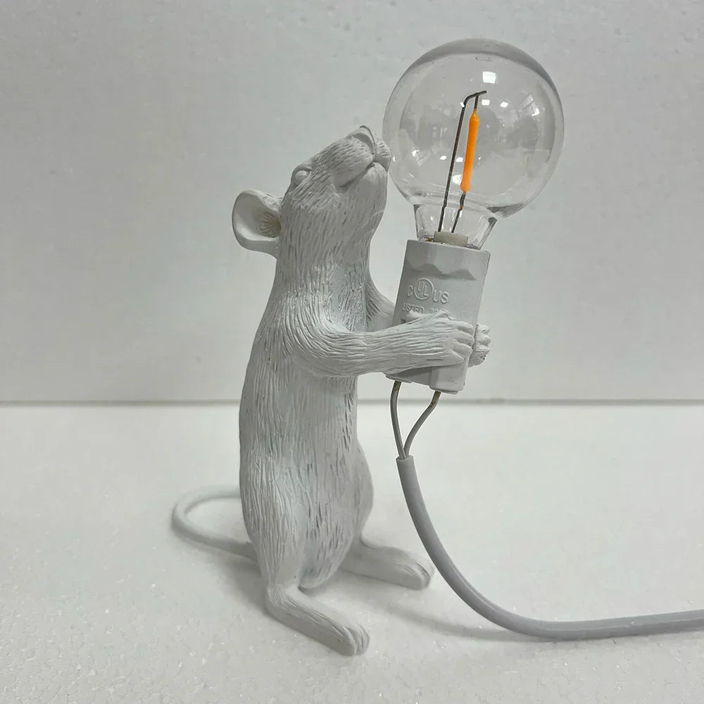 Decorative rat lamp, a unique resin art piece providing soft ambient light for a whimsical space.