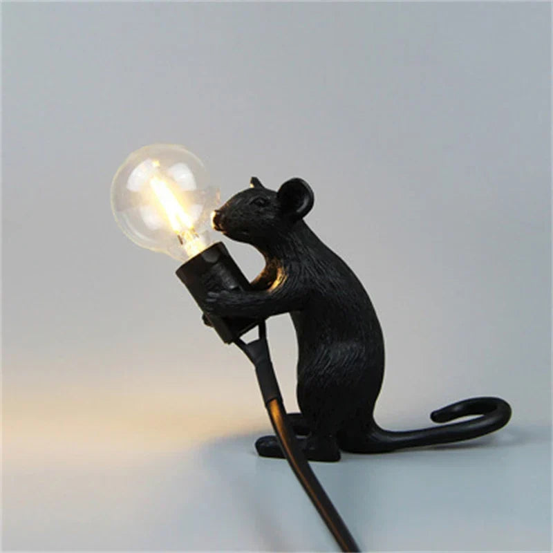 Charming rat lamp, a resin animal desk light providing whimsical decor and soft illumination.