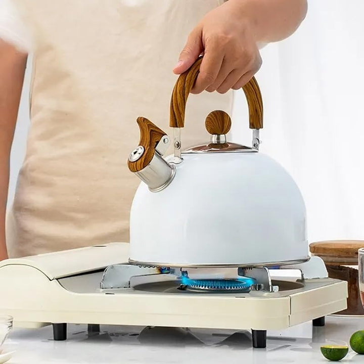 Stainless steel whistling tea kettle for all stovetops; ergonomic insulated handle ensures safe pouring.
