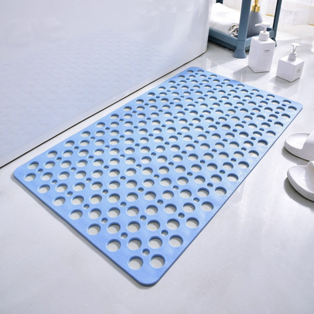 White anti-slip shower mat with numerous suction cups for secure bathroom safety in a wet room.