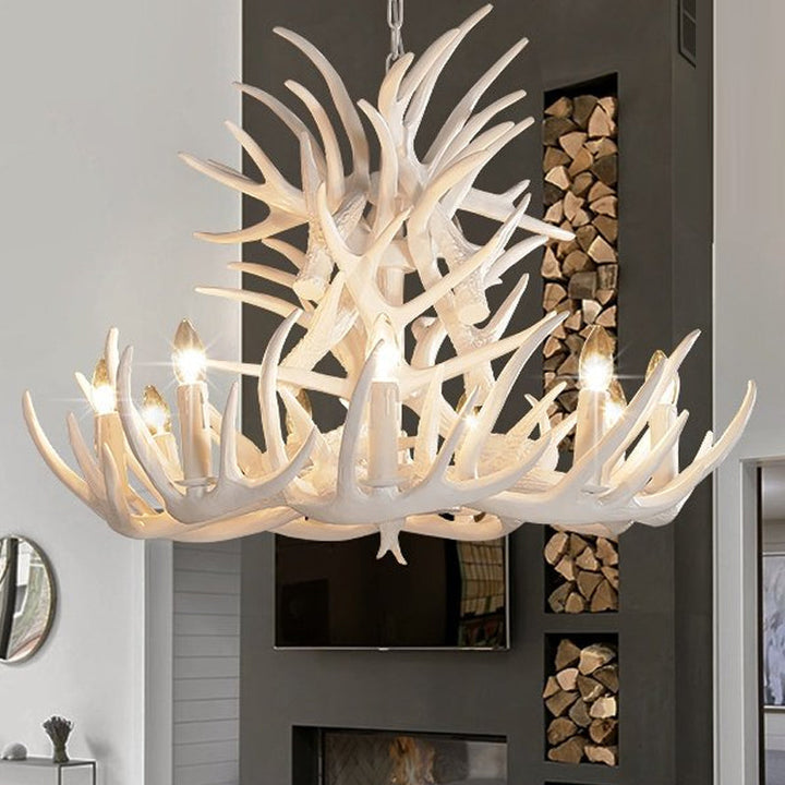 Decorative white antler chandelier, ideal for rustic interiors. White finish, elegant design.