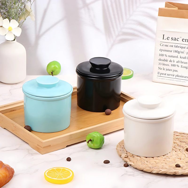 White ceramic butter keeper with water-sealed system, ensuring fresh, soft butter storage on a kitchen counter.