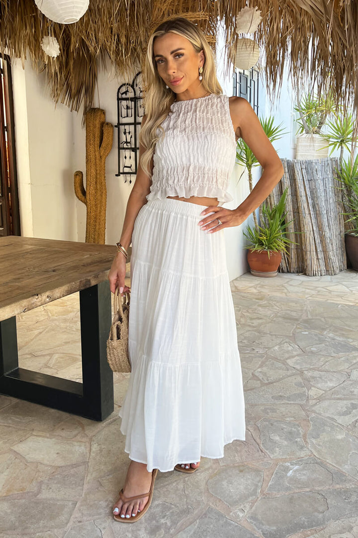White tiered midi skirt for women, high-waisted & flowy. Perfect for elegant summer casual fashion.
