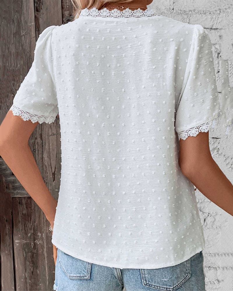 Stylish women's V-neck top with delicate lace trim, perfect for elegant and casual summer outfits.