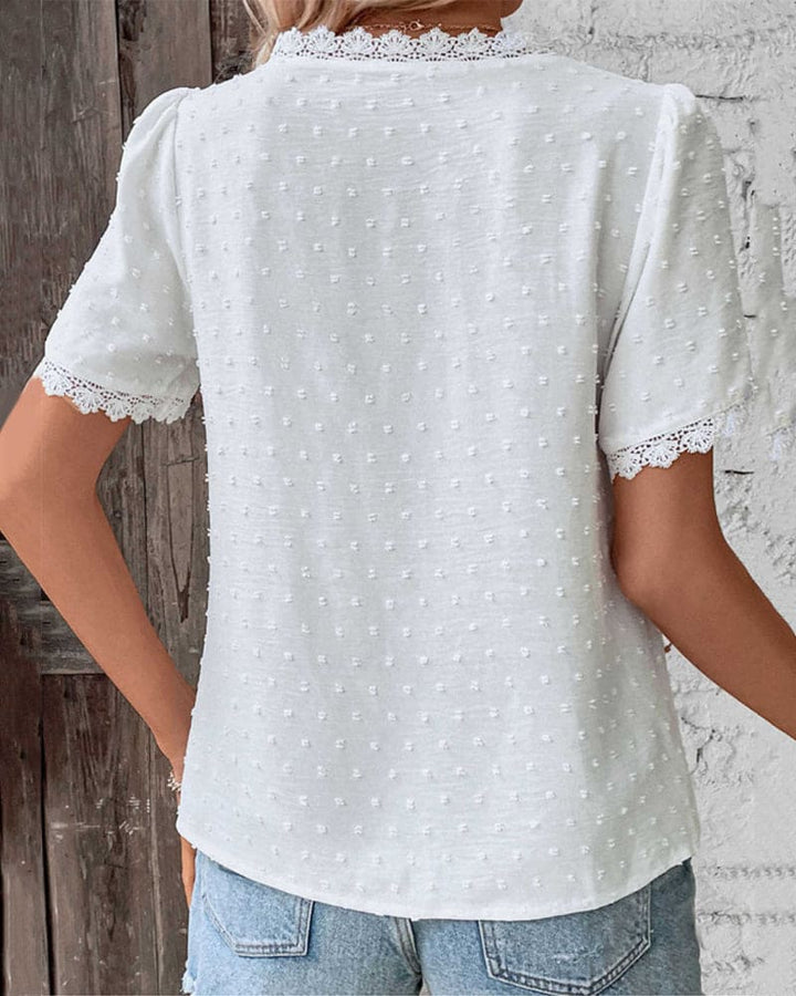 Stylish women's V-neck top with delicate lace trim, perfect for elegant and casual summer outfits.