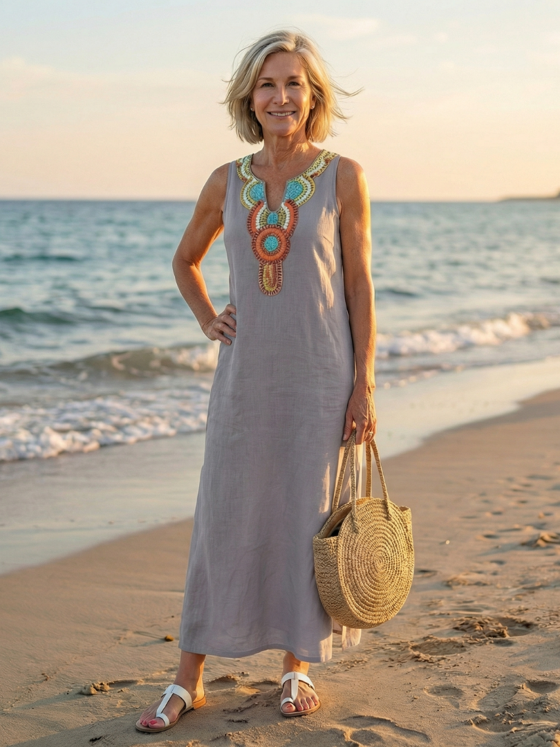 Woman walking in a white embroidered midi dress, enjoying a casual summer day. Perfect travel dress.