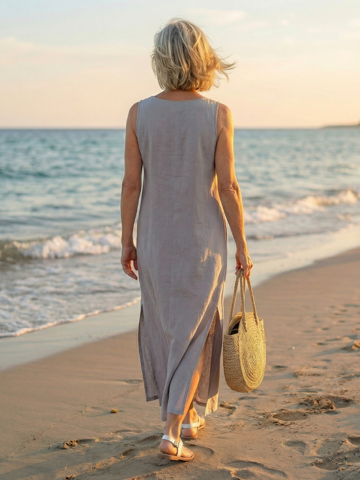 White flowy midi dress for women, sleeveless, with embroidered bodice and a relaxed, airy fit.