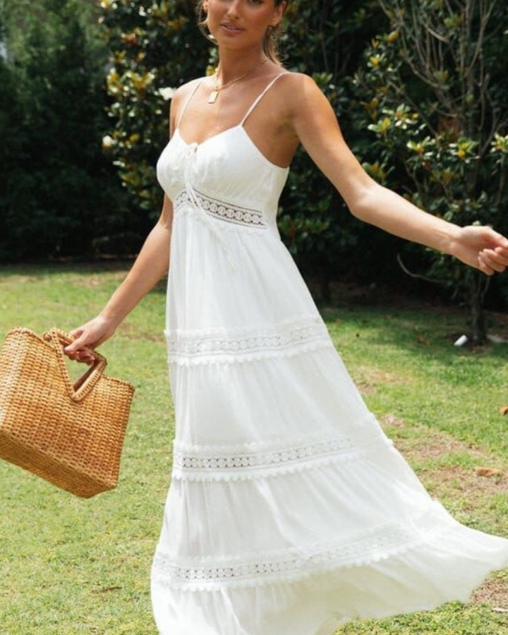 White women's boho maxi dress with delicate lace panels & flowy tiered skirt. Perfect romantic summer style.
