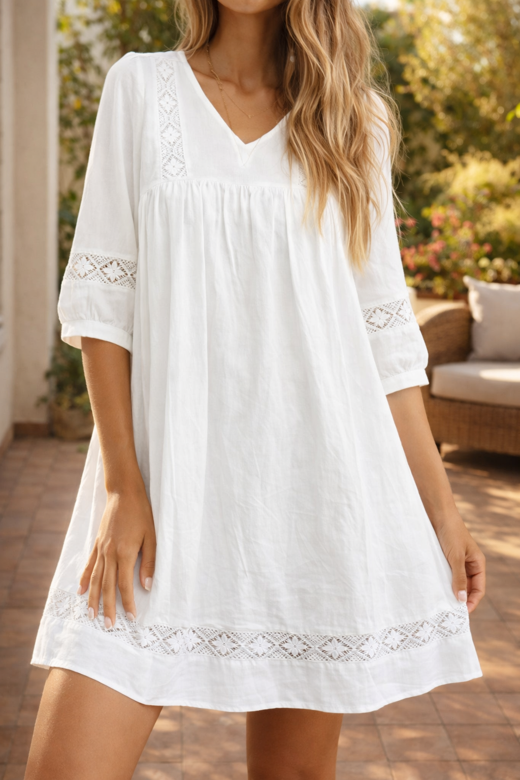 White women's smock mini dress with delicate lace trim, V-neck, & 3/4 sleeves. Perfect for summer & casual wear.