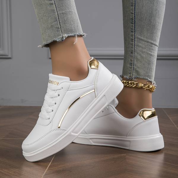 White women's trainers with chic metallic accents, perfect for stylish everyday casual wear.