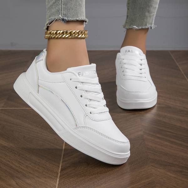 Comfortable white ladies sneakers featuring subtle metallic detailing for a fashionable accent.