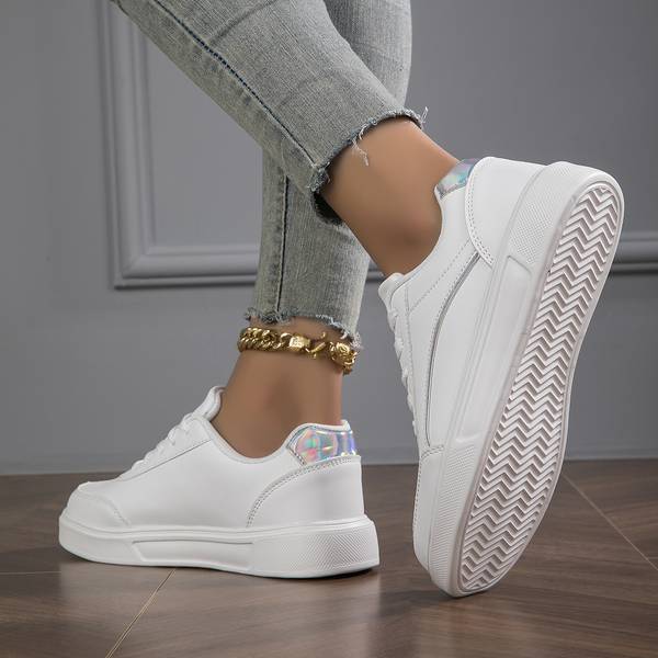 Fashionable white trainers for women, offering versatile style with elegant metallic highlights.