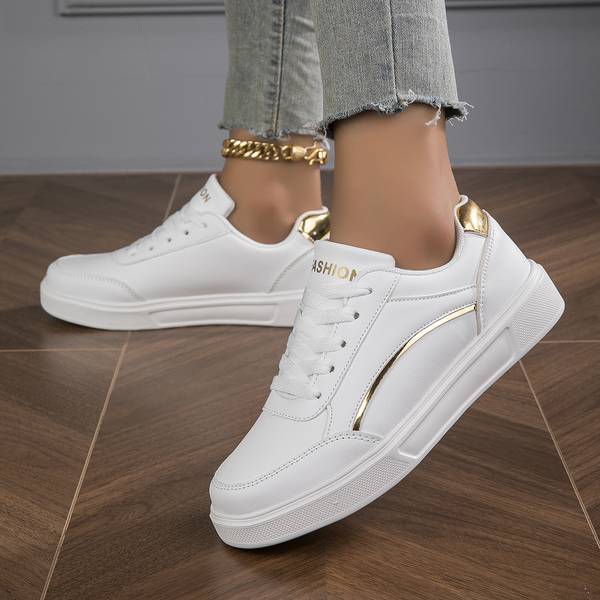 Ladies' white fashion trainers, featuring sleek metallic accents for a contemporary, chic look.