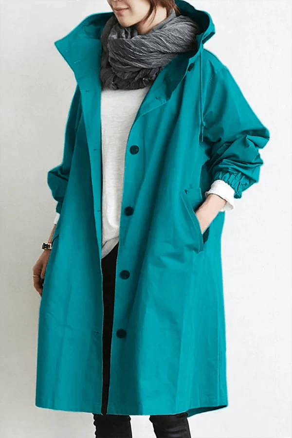 Woman in a chic lightweight waterproof rain cape, perfect for stylish all-weather protection.
