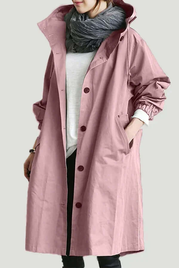 Stylish women's waterproof rain cape in a vibrant color, ideal for spring and fall travel.
