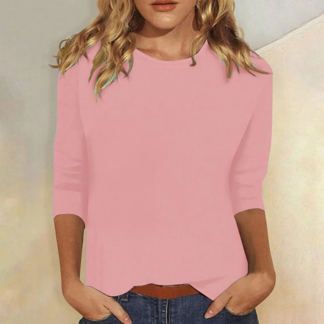 Woman models a relaxed fit 3/4 sleeve crew neck top in soft fabric, perfect for casual everyday style.