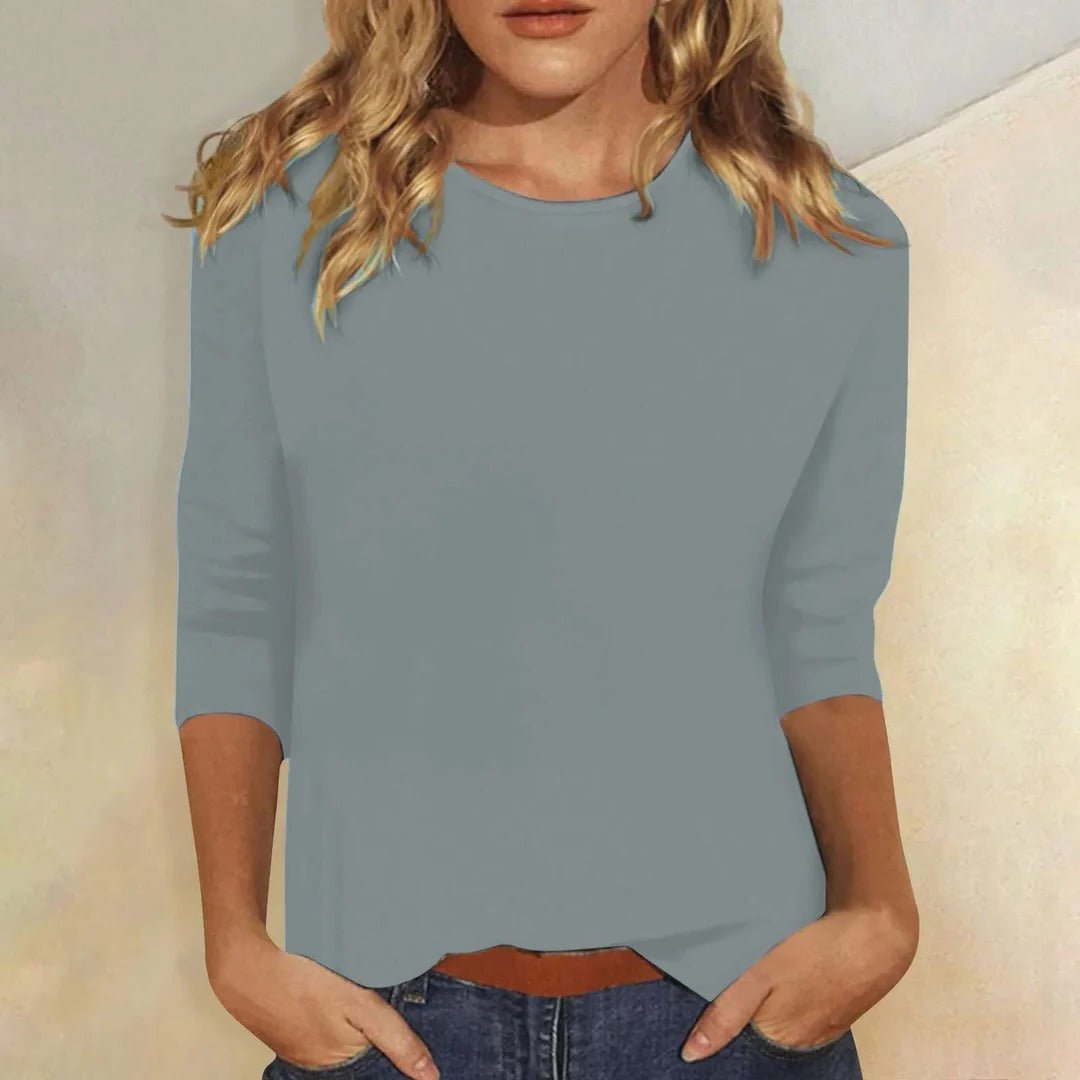 Stylish woman wearing a basic, comfortable 3/4 sleeve crew neck top with a relaxed fit for versatile fashion.