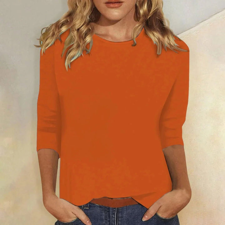 Neatly folded women's relaxed fit 3/4 sleeve crew neck top, a versatile and comfortable basic for your wardrobe.