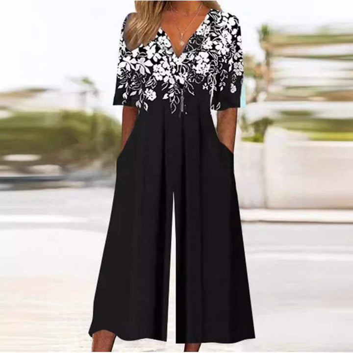 Close-up of the vibrant floral print on a women's bohemian V-neck half-sleeve wide-leg jumpsuit fabric.