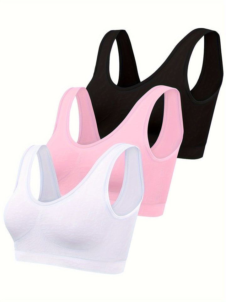 Soft pink women's 3-piece seamless tank top and sports bra set. Ideal for yoga, gym, or comfortable loungewear.
