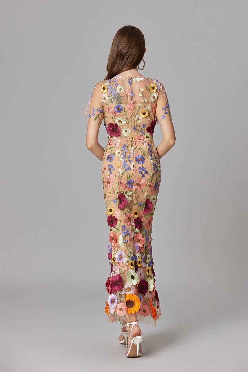 Chic women's sleeveless maxi dress with vibrant 3D floral appliqué, stylish spring/summer fashion.
