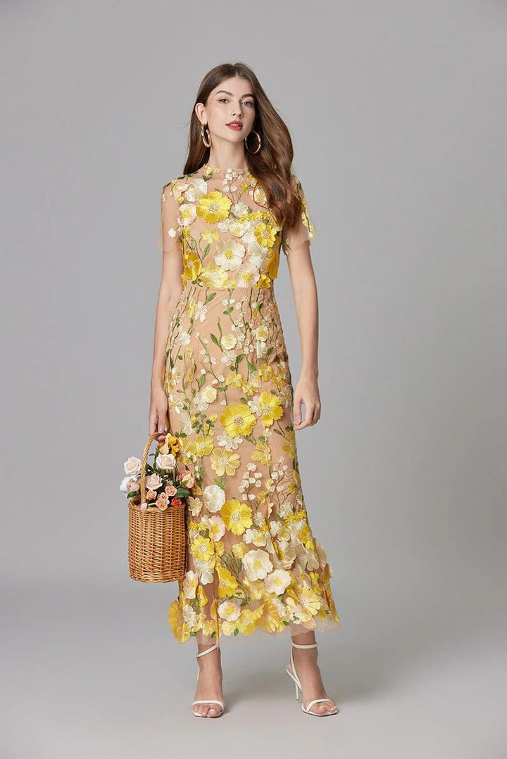 Woman enjoying an evening in a chic 3D floral appliqué sleeveless maxi dress, feminine style.