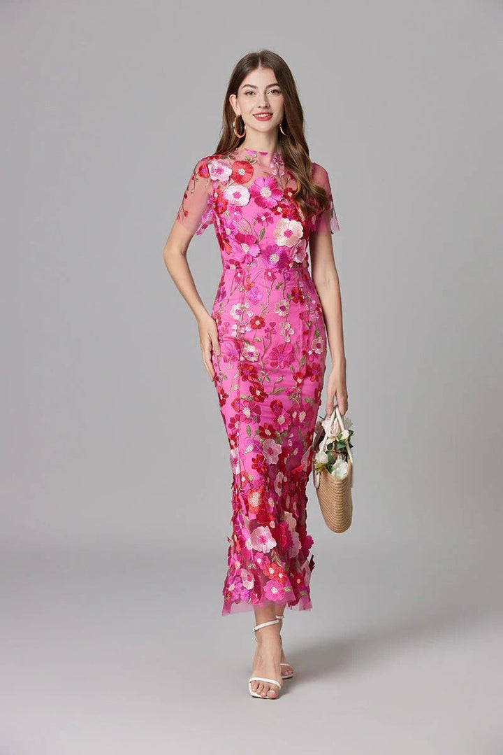 Close-up of intricate 3D floral appliqué on an elegant women's sleeveless maxi dress.