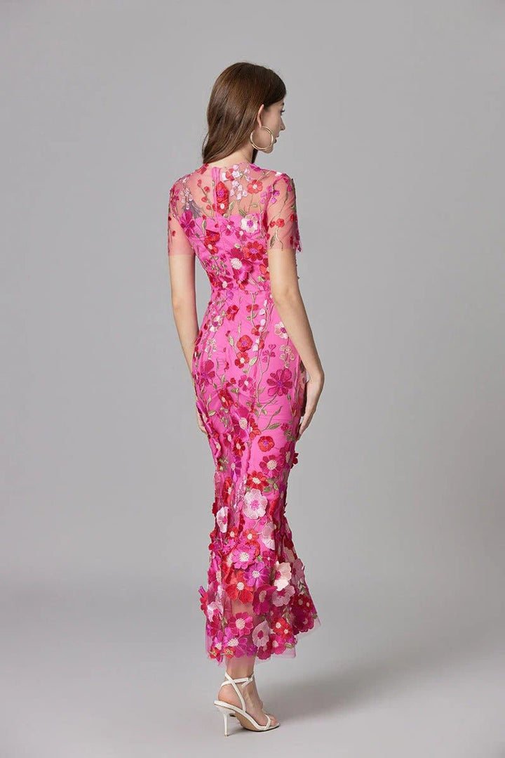 Back view of an elegant women's sleeveless maxi dress with delicate 3D floral details, special occasion.