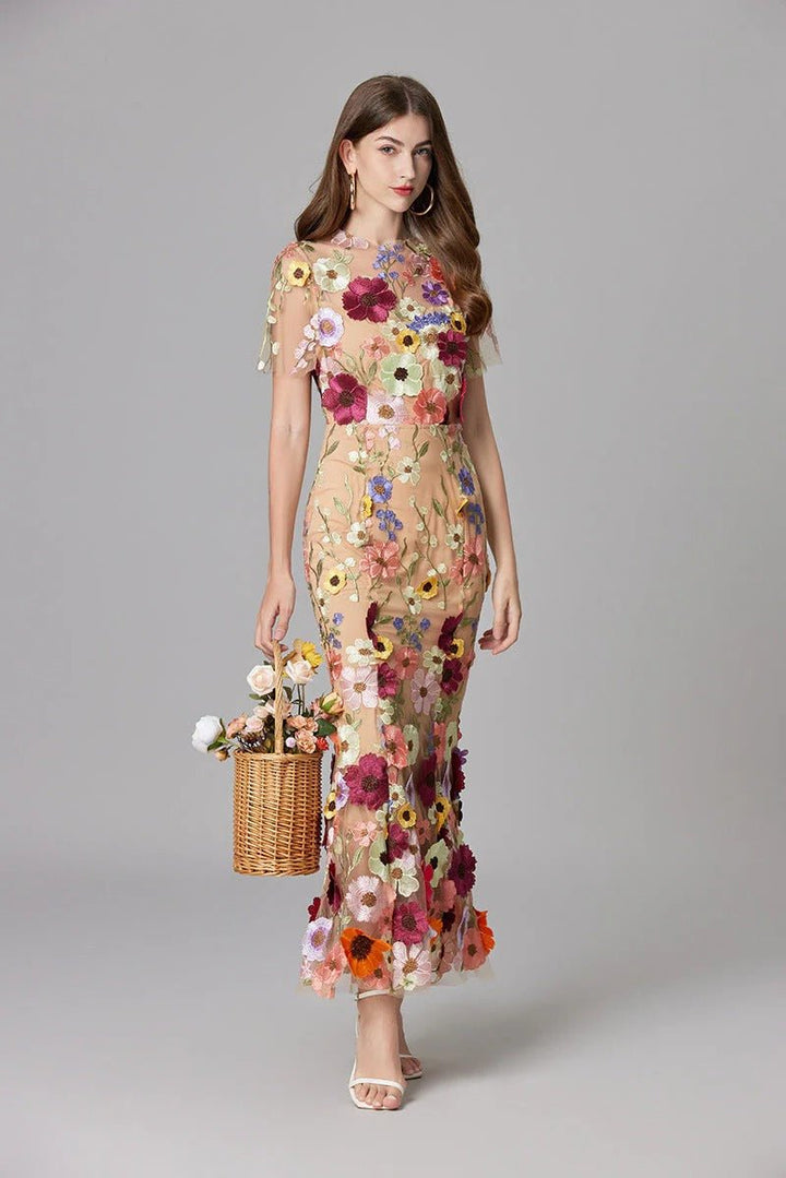 Textured 3D floral appliqué on a luxurious women's sleeveless maxi dress, an elegant evening gown.