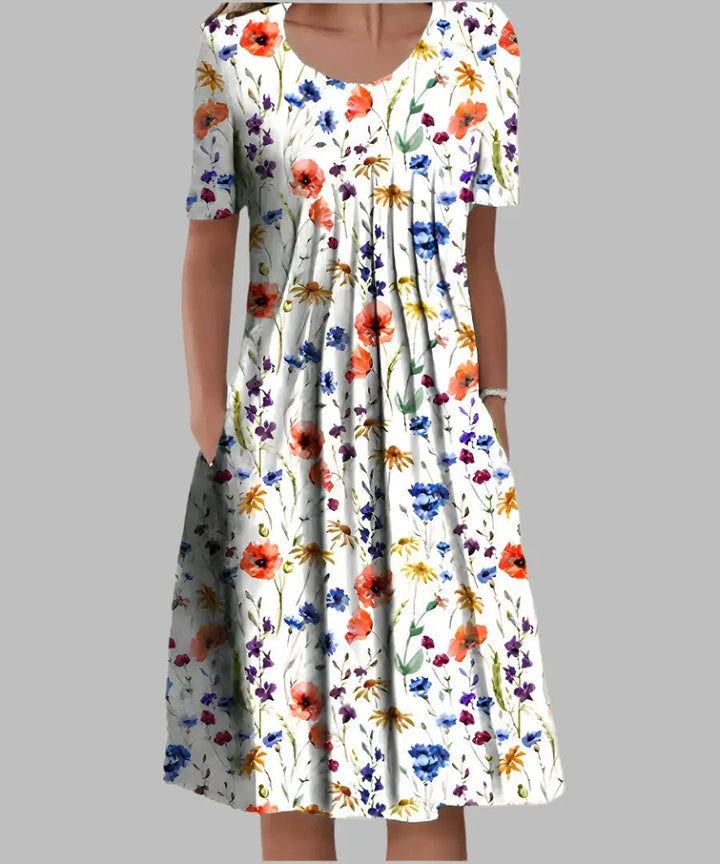 Women's A-line floral midi dress with short sleeves. Perfect elegant summer day dress with wildflower print.