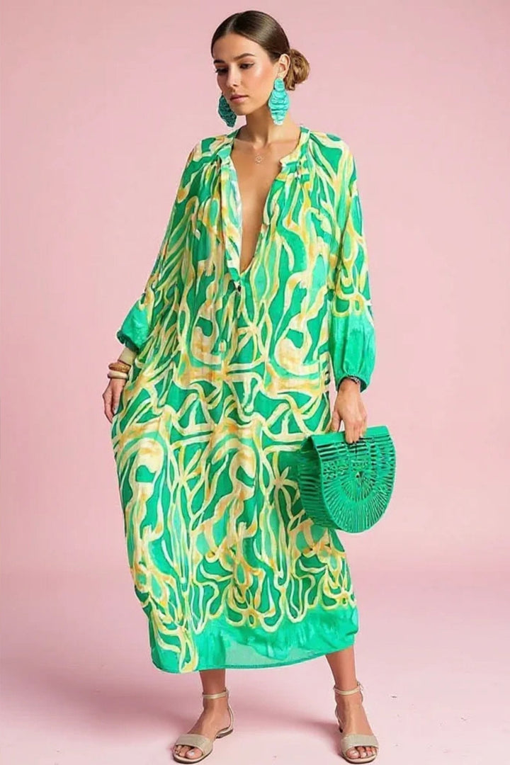 Women's abstract print kaftan maxi dress with a relaxed-fit and V-neck, perfect for summer resort wear.
